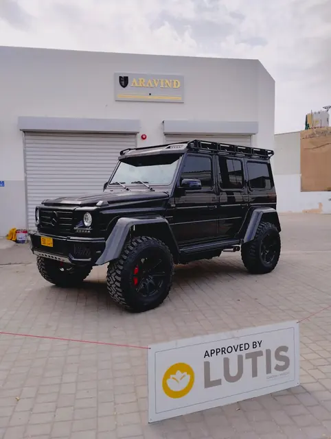 Mercedes-Benz G 500 4x4² outside the workshop with an Approved by Lutis board