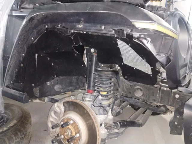 Front suspension and hub assembly exposed during a repair